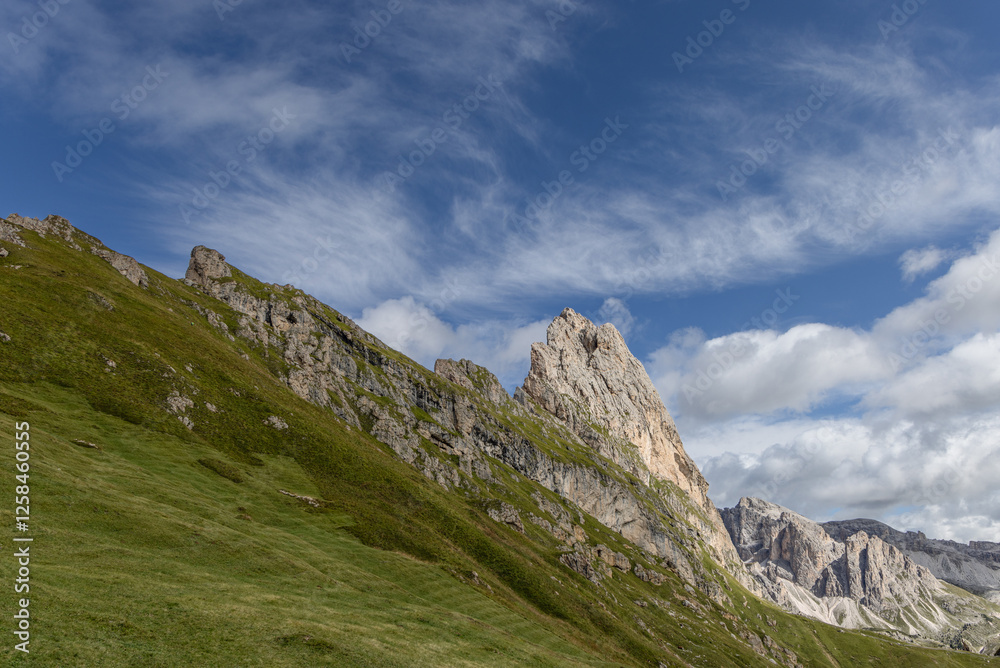 Obraz premium Expansive shot of the iconic Seceda plateau meadow in Italy’s Dolomites, showcasing lush green hills and dramatic rocky peaks