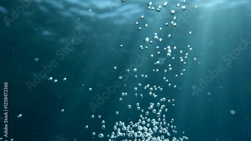 air bubbles slow  underwater coming up scenery dark blue and sun shine ocean scenery from scuba  divers background photo