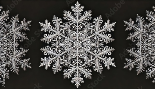 A single intricate snowflake on a black background showcasing sharp crystalline details. photo