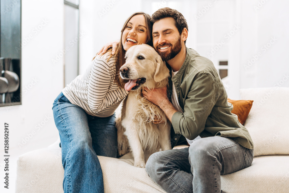 Happy couple embracing golden retriever on sofa at home Happy couple embracing golden retriever on sofa at home