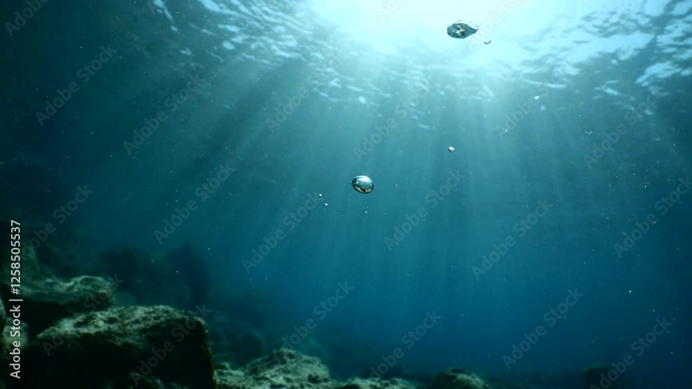 air bubbles slow  underwater coming up scenery dark blue and sun shine ocean scenery from scuba  divers background
