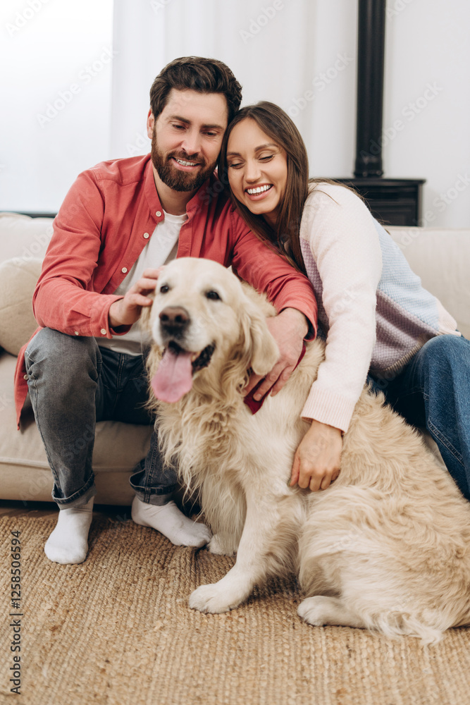 Happy couple cuddling with golden retriever dog at home Happy couple cuddling with golden retriever dog at home