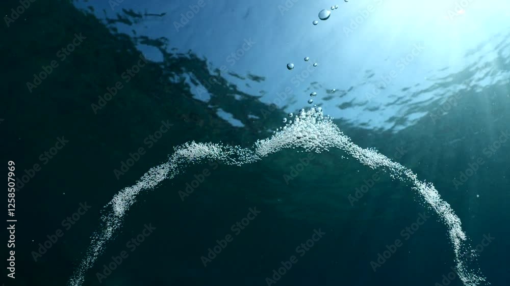 air bubbles slow  underwater coming up scenery dark blue and sun shine ocean scenery from scuba  divers background