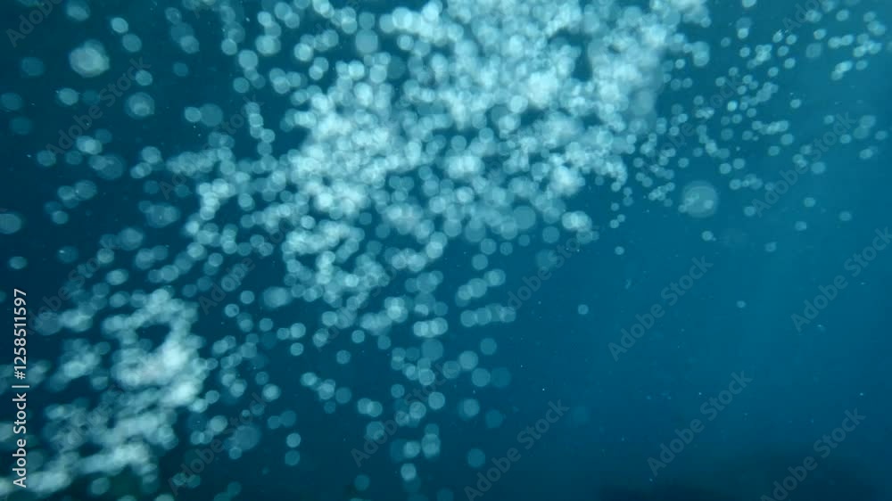 air bubbles slow  underwater coming up scenery dark blue and sun shine ocean scenery from scuba  divers background