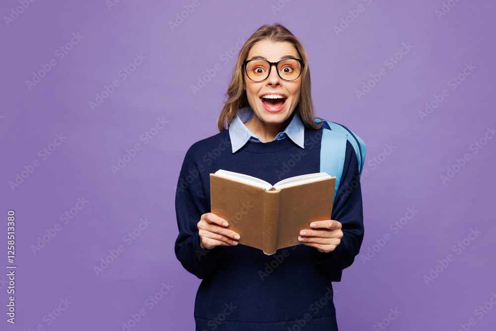 Young shocked surprised happy girl student wear blue casual clothes glasses backpack bag hold read novel book isolated on plain pastel light purple background. High school university college concept. Young shocked surprised happy girl student wear blue casual clothes glasses backpack bag hold read novel book isolated on plain pastel light purple background. High school university college concept.
