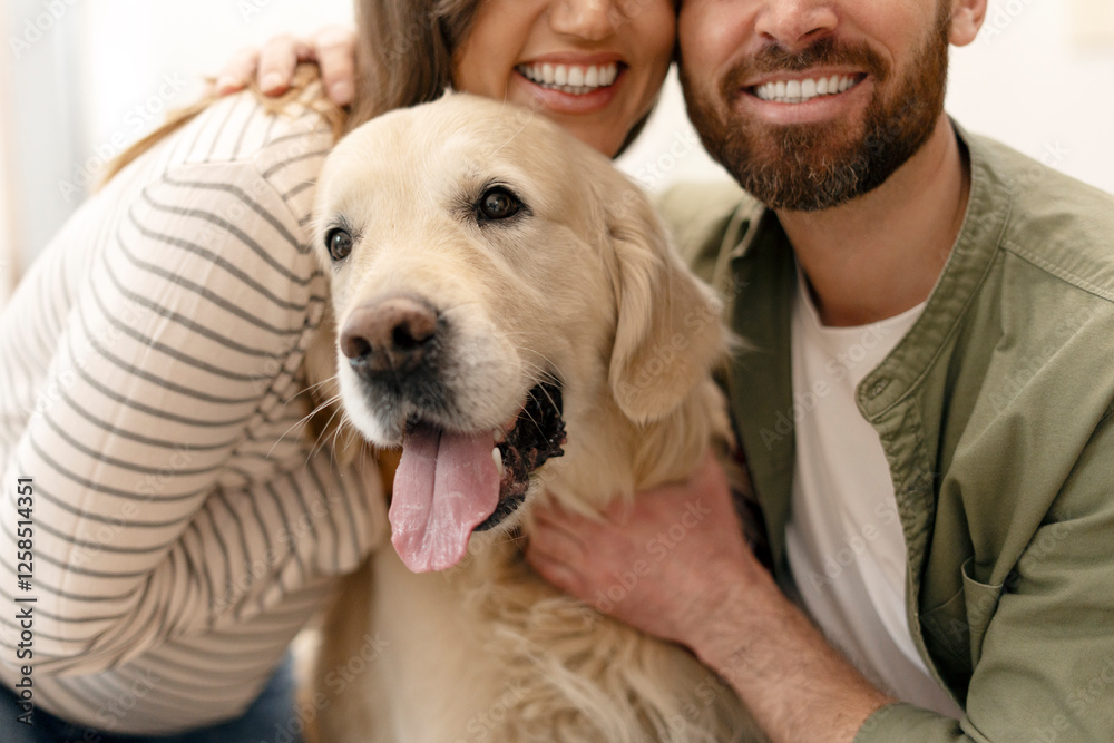 Happy couple hugging and smiling with their golden retriever dog Happy couple hugging and smiling with their golden retriever dog