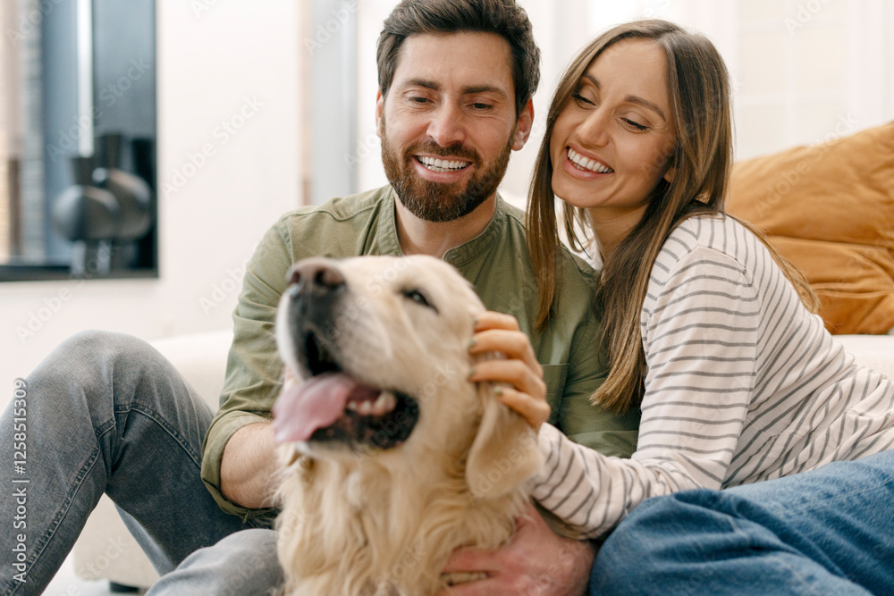Happy couple bonding with their golden retriever at home Happy couple bonding with their golden retriever at home