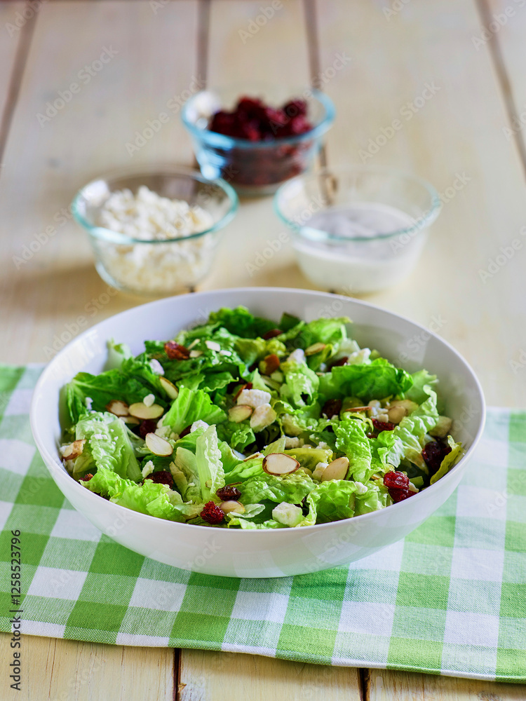 mixed green salad topped with dried fruit and nuts mixed green salad topped with dried fruit and nuts