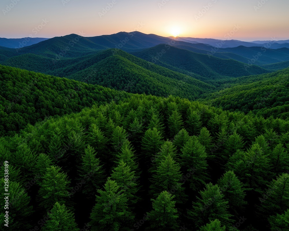 Fototapeta premium Breathtaking aerial view of lush green mountains at sunset with vibrant sky colors.