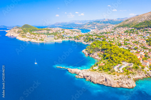 A breathtaking view of the Dubrovnik coastline, showcasing the Adriatic Sea, rugged cliffs, and lush Mediterranean landscape, with untouched nature and warm sunlight enhancing this Dalmatian gem.