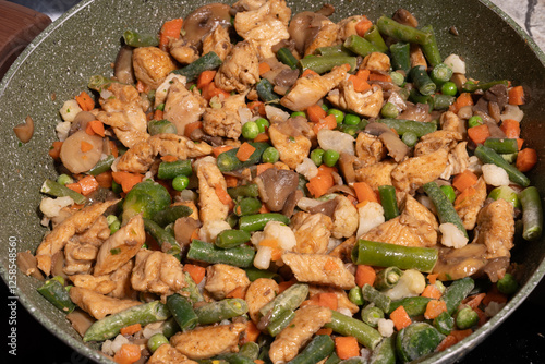 Obraz na płótnie A close-up view of a pan filled with a variety of frozen mixed vegetables, including green beans, peas, carrots, cauliflower, and Brussels sprouts. w salonie