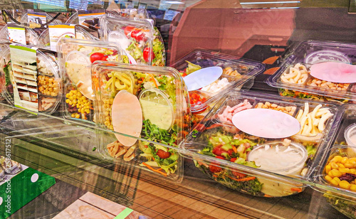 Prepackaged salads and drinks in a commercial supermarket refrigerator