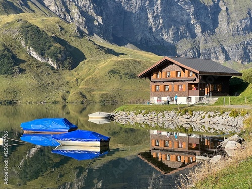 Boats on the artificial alpine lake Melchsee or Melch lake in the Uri Alps mountain massif, Melchtal - Canton of Obwalden, Switzerland (Kanton Obwald, Schweiz) photo