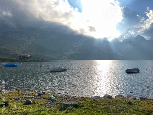 Boats on the artificial alpine lake Melchsee or Melch lake in the Uri Alps mountain massif, Melchtal - Canton of Obwalden, Switzerland (Kanton Obwald, Schweiz) photo