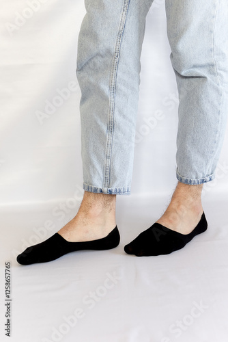 Male legs in black short summer socks on a background photo