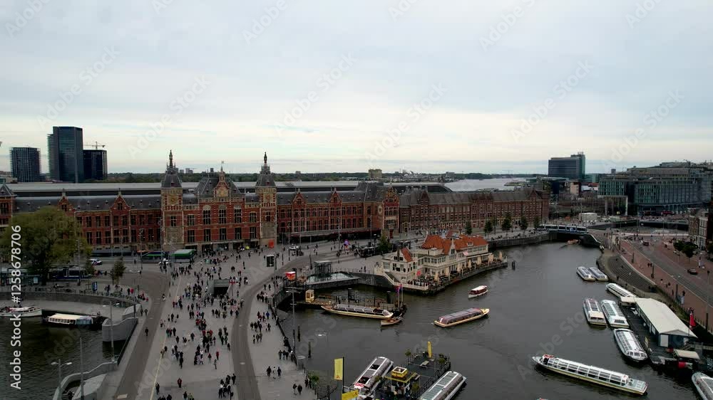 Beautiful aerial cinematic footage of the Amsterdam Centraal Train Station  A historic hub with canals, bikes, cafes, and stunning city views all around Amsterdam