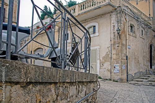 square in Scicli with a vespa, Sicily, Italy photo