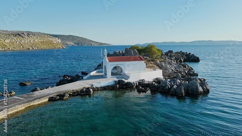 Little chapel church of Agios Isidoros in the sea over the rocks, Chios island, Greece photo