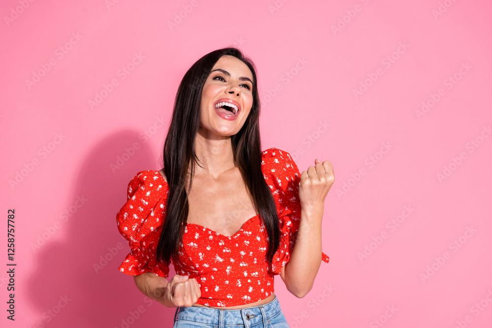 Portrait of young hispanic brunette beautiful woman in red blouse raised fists up winning coupons for discount isolated on pink color background Portrait of young hispanic brunette beautiful woman in red blouse raised fists up winning coupons for discount isolated on pink color background