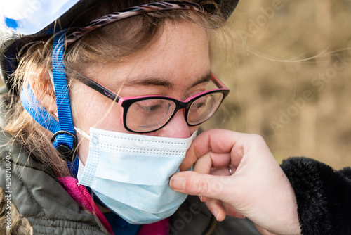 39 yo woman with Down Syndrome gettinga helping hand from her female friend, Tienen, Flanders, Belgium photo