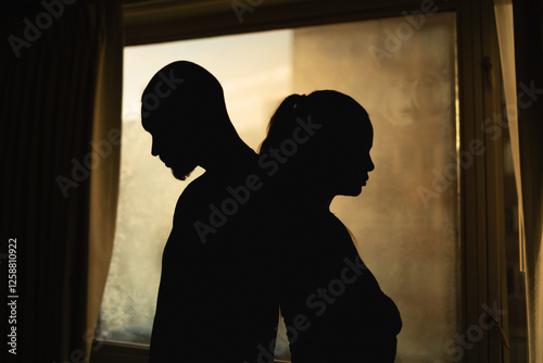 silhouette of a young couple upset,  having disagreement, relationship problem, misunderstanding  photo