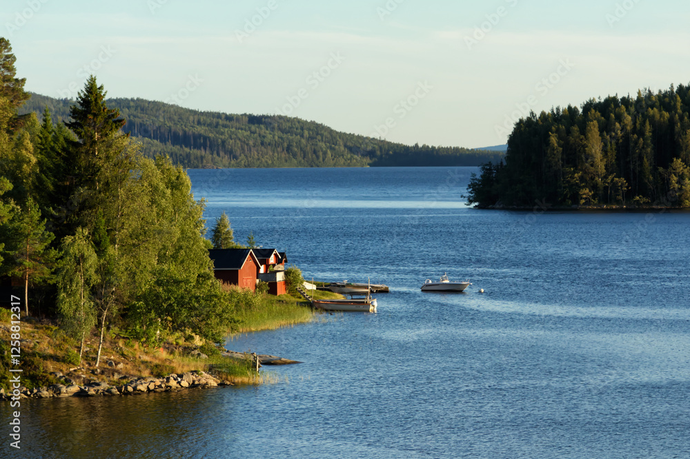 Small wooden summer houses by the lakeside in the north of Sweden