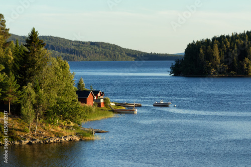 Obraz na płótnie Small wooden summer houses by the lakeside in the north of Sweden w salonie