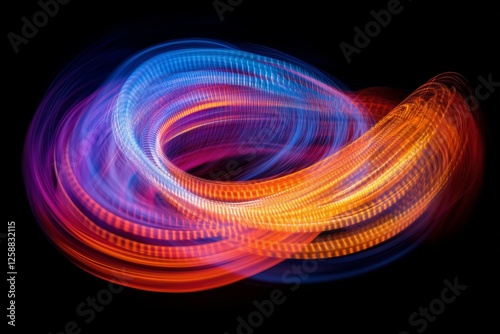 Colorful light trails create mesmerizing patterns in darkness during a nightt...