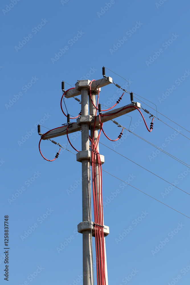 A reinforced concrete utility pole designed to carry electrical lines with insulators and conductors. A reinforced concrete utility pole designed to carry electrical lines with insulators and conductors.
