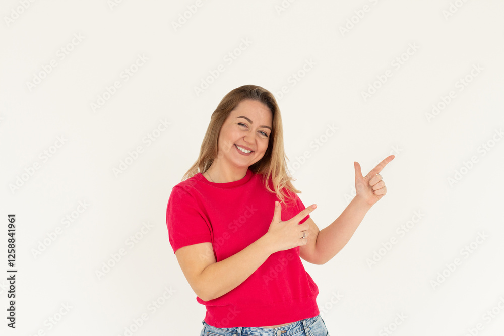 Hey look. Smiling pretty female model pointing fingers right at empty space and inviting to check it out, showing advertisement on white background. Hey look. Smiling pretty female model pointing fingers right at empty space and inviting to check it out, showing advertisement on white background.