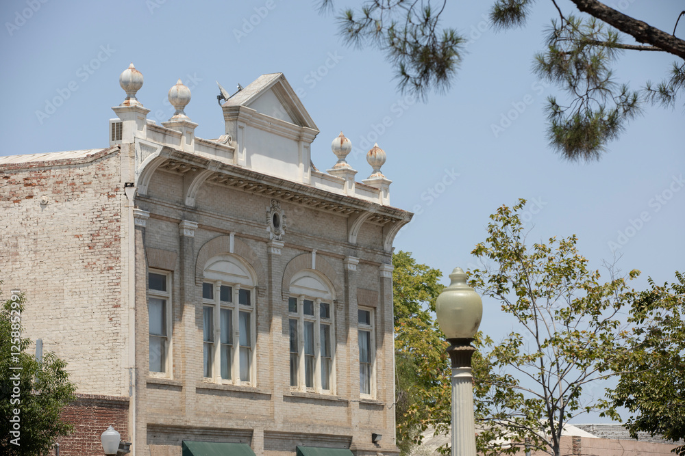 Afternoon sun shines on historic buildings of downtown Hanford, California, USA.