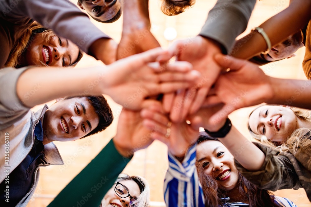 Obraz premium Diverse group of people, hands in unity, team spirit. Group of people, hands together, showing unity. Team spirit, diverse group, hands in unity, teamwork. Business team stacking hands together.