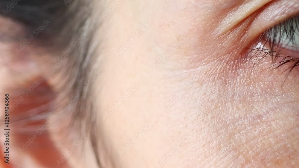 Close upview of woman eyes. Macro shot of middle aged female wrinkles near the eyes. Concept of aging, old skin of wrinkled face of caucasian. Beauty portrait.