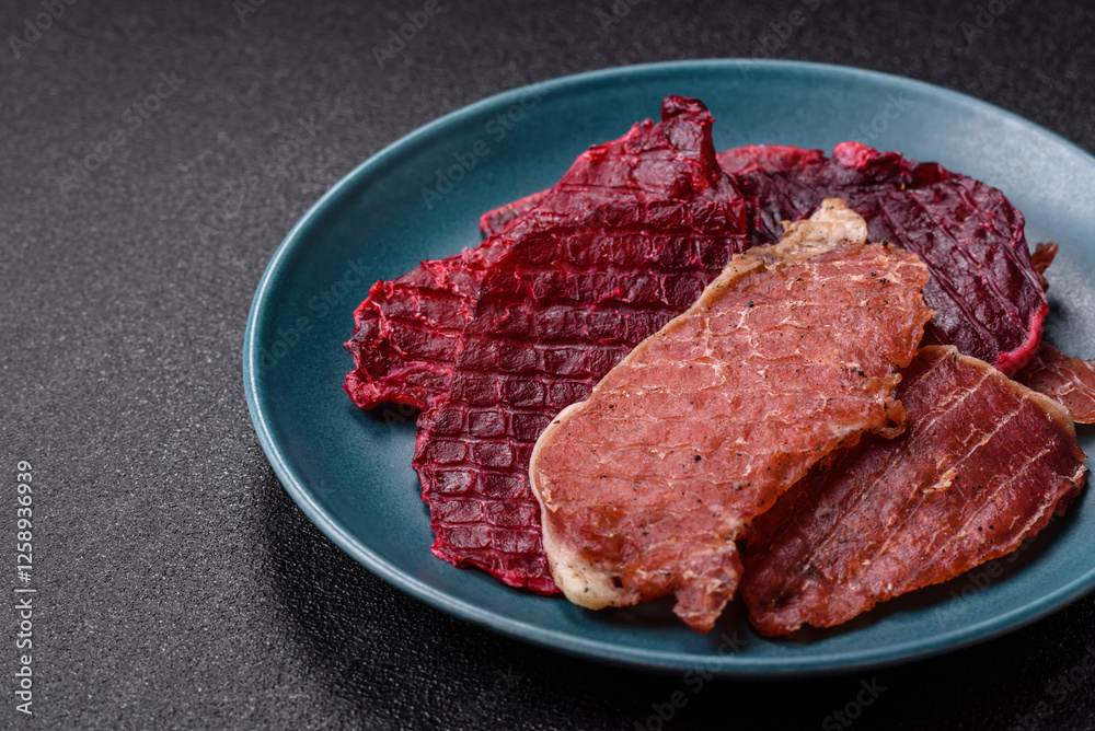 Jerky, dried pork meat slices with salt and spices