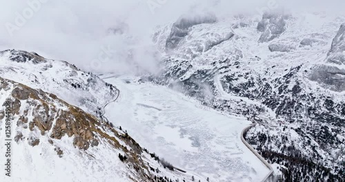 Aerial drone view of Portavescovo covered in snow, in Arabba, Italy photo