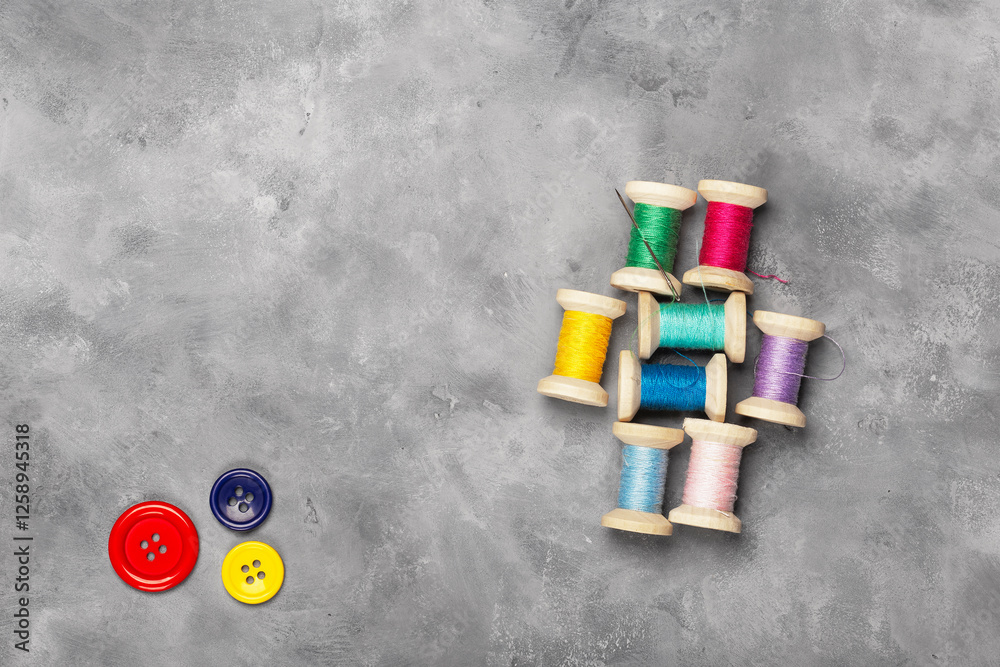 Obraz premium Amazing top view of colorful sewing threads and bobbins