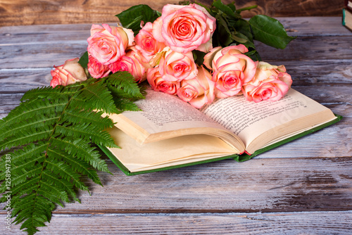 book and flowers on table