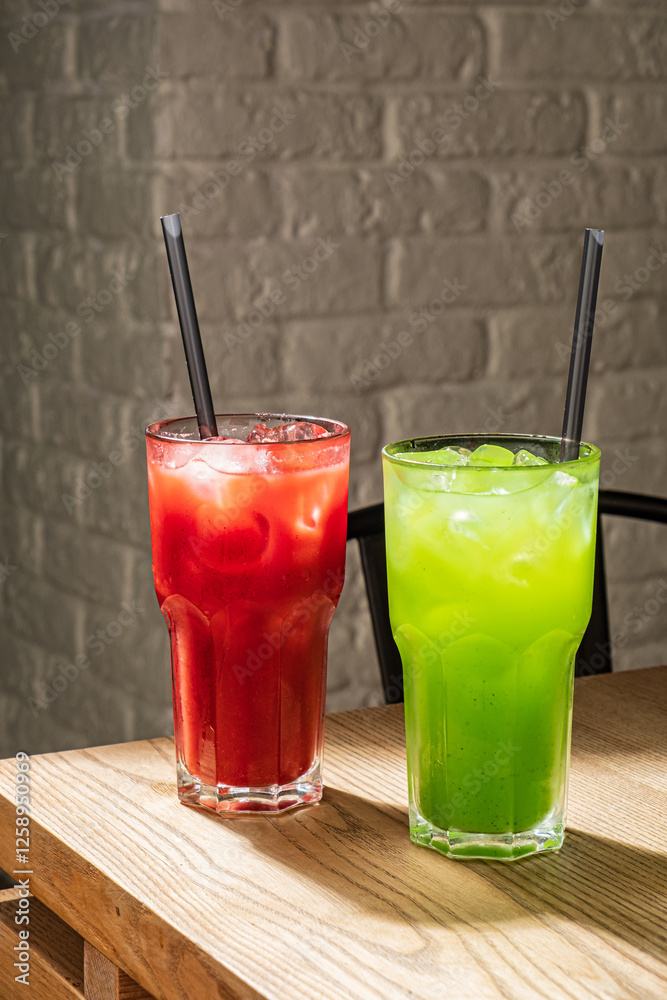 Refreshing Summer Beverage Selection Featuring Vibrant Red and Green Drinks Served in Tall Glasses on a Wooden Table. Refreshing Summer Beverage Selection Featuring Vibrant Red and Green Drinks Served in Tall Glasses on a Wooden Table.