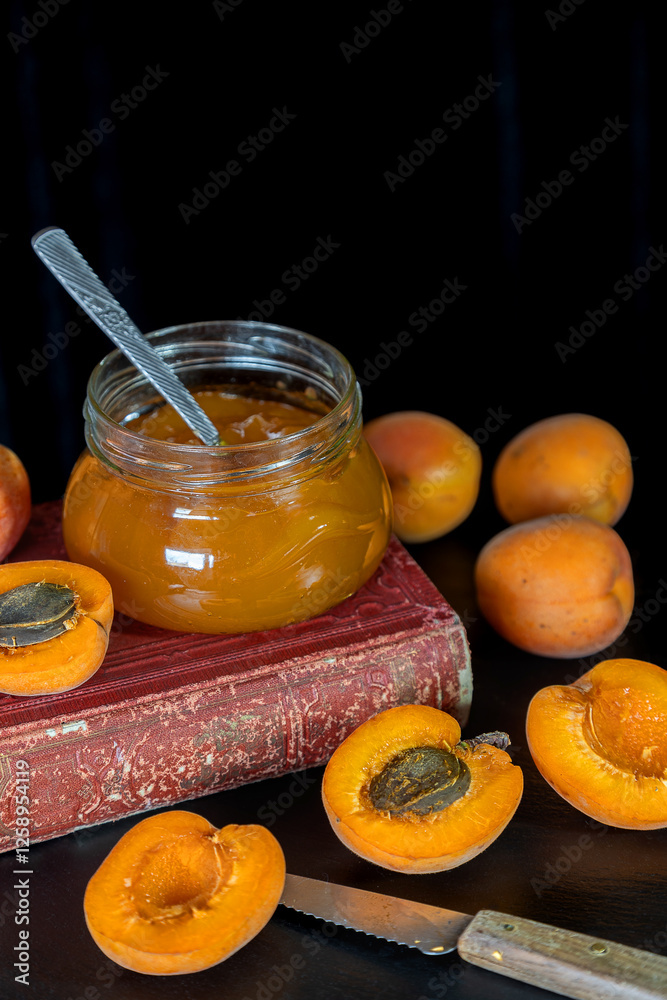 Homemade apricot jam on stone table with some fresh cut apricot fruit - with copy space Homemade apricot jam on stone table with some fresh cut apricot fruit - with copy space
