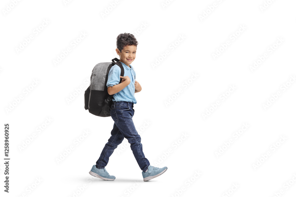 Kid with a backpack walking and smiling at camera Kid with a backpack walking and smiling at camera
