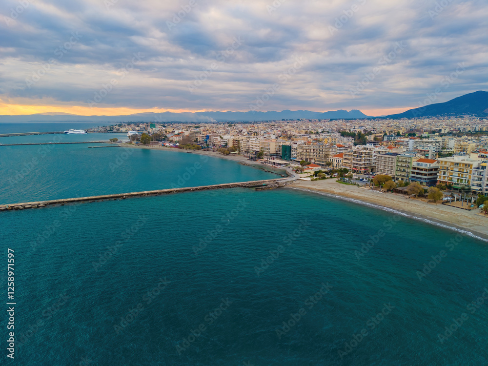 Aerial photo of Kalamata city, blue long beach in Messenia during dramatic sunset, Peloponnese, Greece. Aerial photo of Kalamata city, blue long beach in Messenia during dramatic sunset, Peloponnese, Greece.