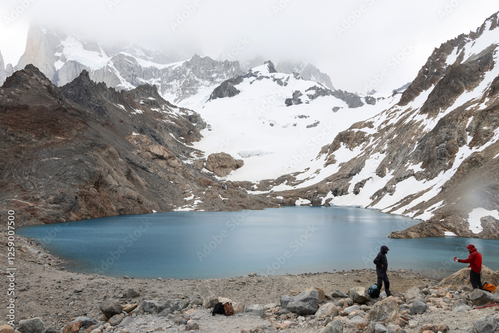 Fototapeta premium Two travelers interacting at Laguna de Los Tres