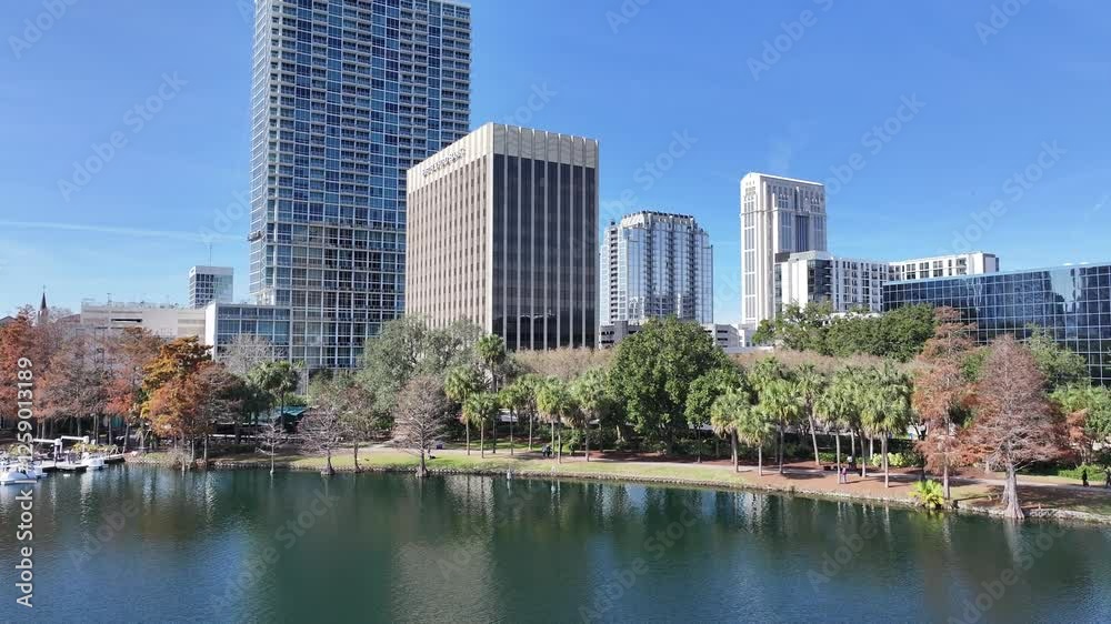 Eola Park At Orlando Florida United States. Aerial View Of A High-Rise Buildings And Traffic Showcasing Urban Life. Industrial Landscape Skyscrapers Amazing. Skyscrapers. Orlando Florida. Eola Park At Orlando Florida United States. Aerial View Of A High-Rise Buildings And Traffic Showcasing Urban Life. Industrial Landscape Skyscrapers Amazing. Skyscrapers. Orlando Florida.