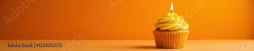 Single yellow cupcake, lit candle, orange backdrop,  candle,  background,  celebration