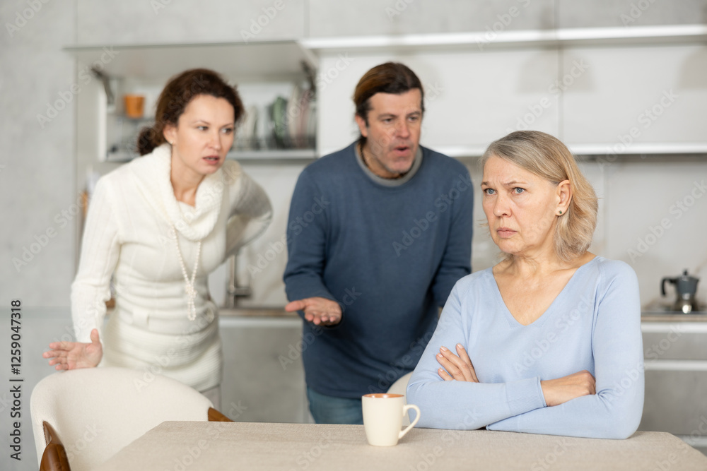 Obraz premium Adult children man and woman clashed over financial question with elderly woman mother. Family feuds, generational conflict, misunderstanding due to different views and opinions