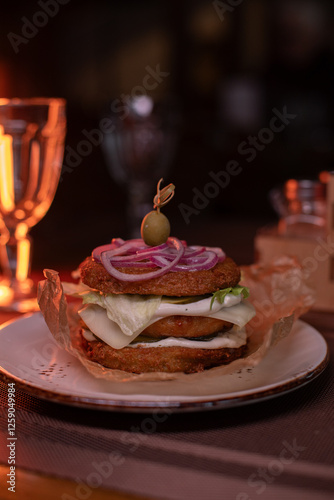 Juicy burger made from draniki and meat patties, lettuce, onion on top and olive. A delicious photo for a menu, culinary website, or an advertisement for catering establishments photo