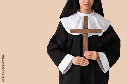 Young nun with cross on bei...