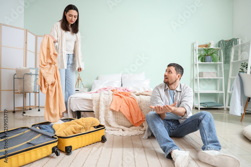 Upset young woman packing c...