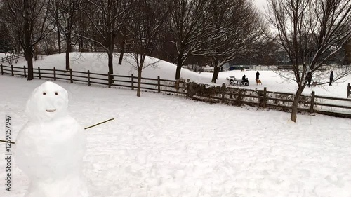 Camera Pans from Off-Leash Dog Park to a Snowman