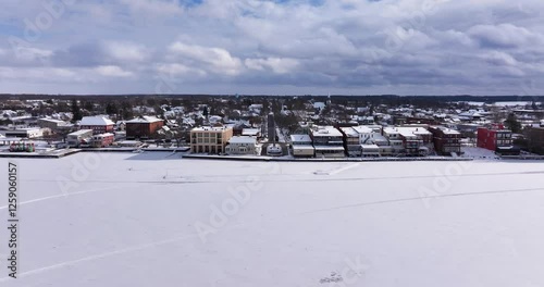 Clayton, NY, USA - 02-09-2025:  Winter aerial video Clayton, NY along a frozen St Lawrence River
